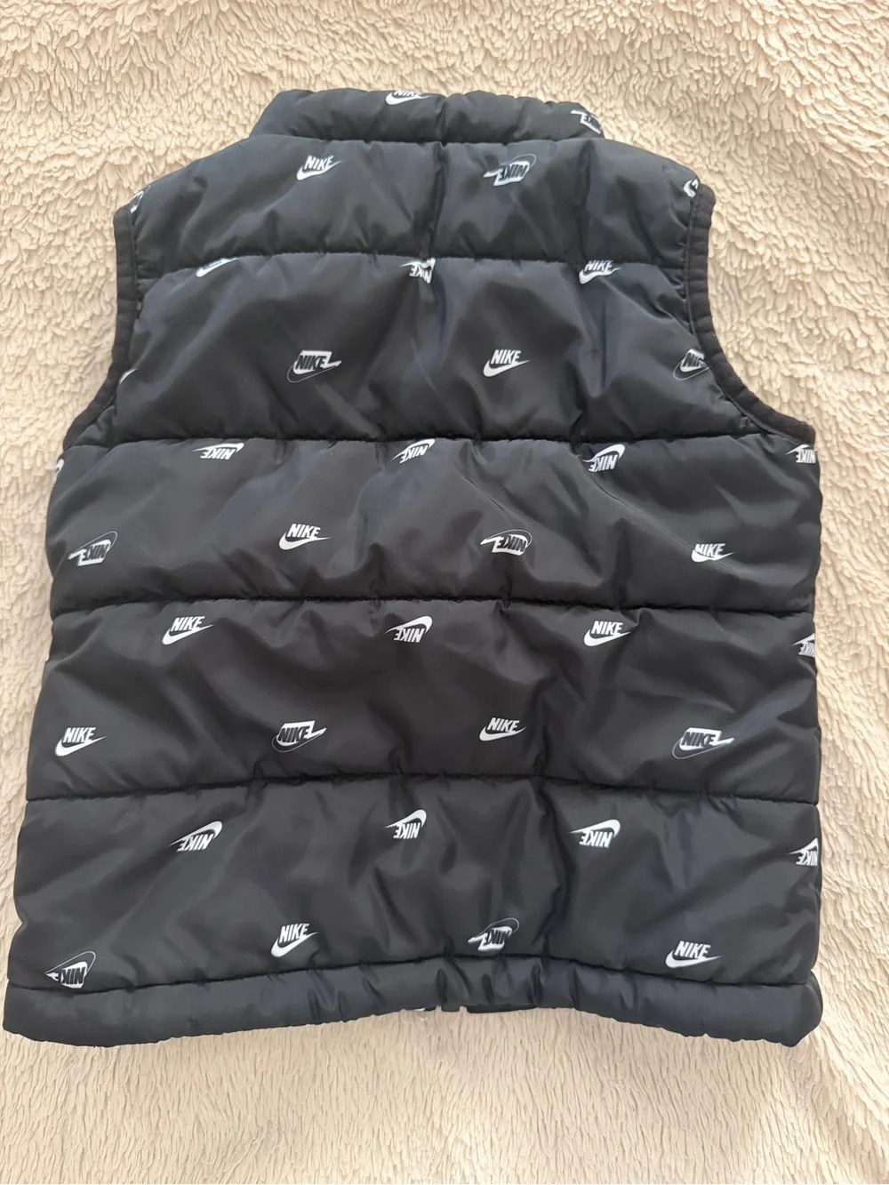 Kids black padded vest with Nike logos